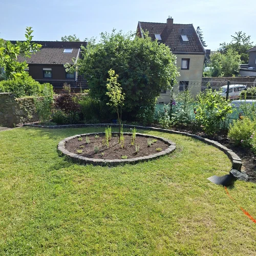Ein Garten in Bearbeitung. Neueste Entwicklung: eine gemauerte Beetumrandung mit Basaltstein, in Cottage Garden Look.